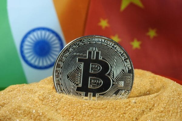 Indian and Chinese flags with global finance imagery representing BRICS and international economic relations