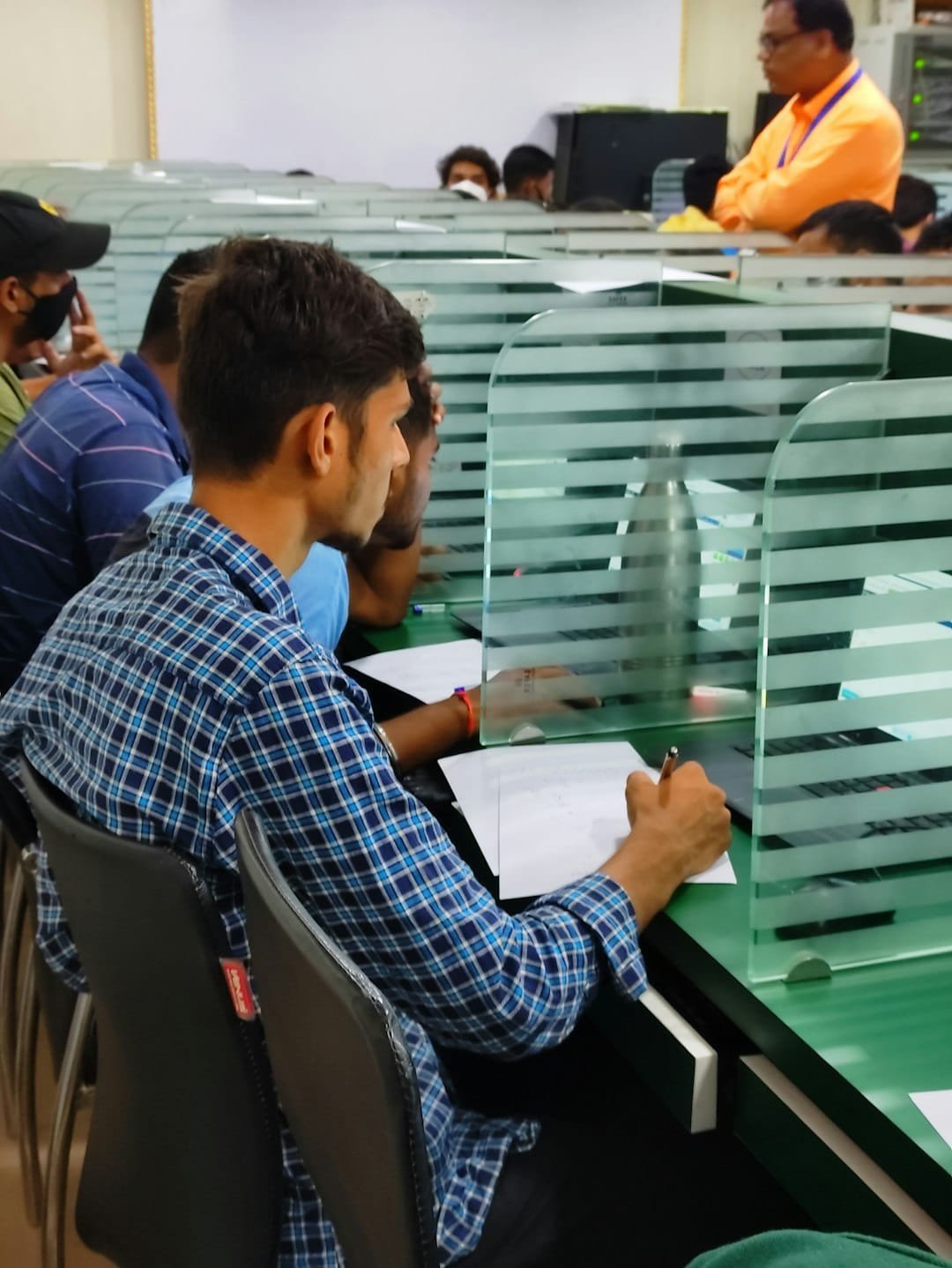 Candidates completing recruitment documents for a competitive examination