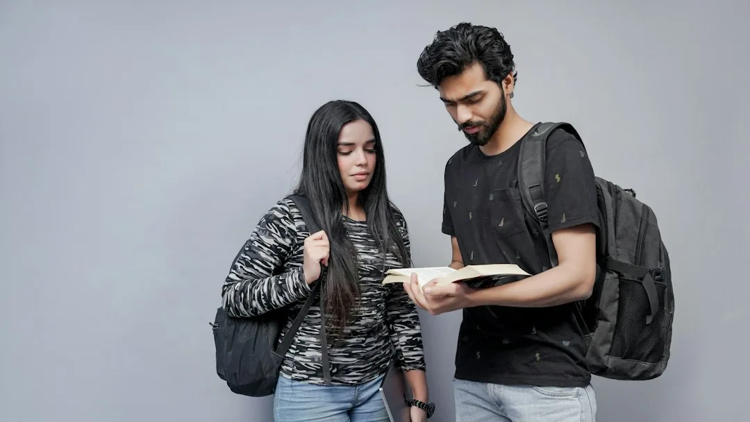 Indian students preparing for competitive exams with books and a laptop