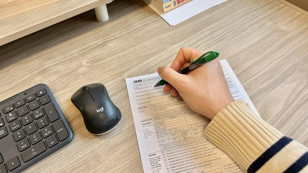 Student completing a competitive exam paper at a study desk