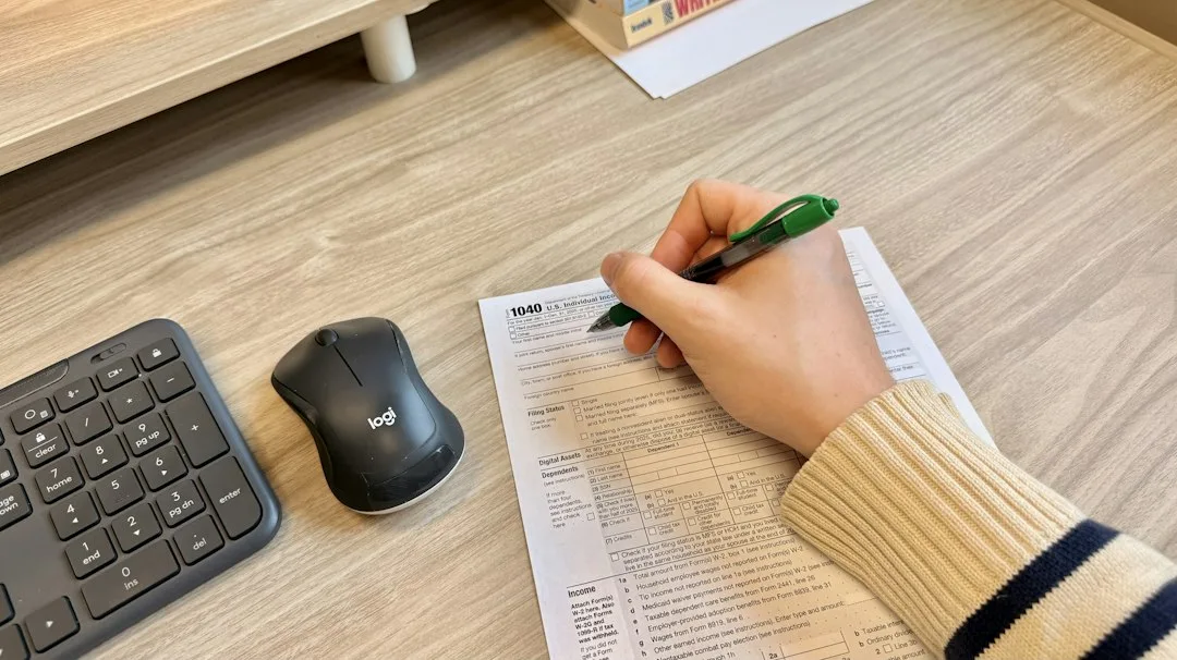 Student completing a competitive exam paper at a study desk