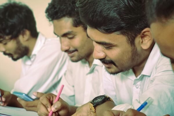 Students taking notes during a class, representing competitive-exam preparation and current-affairs study.