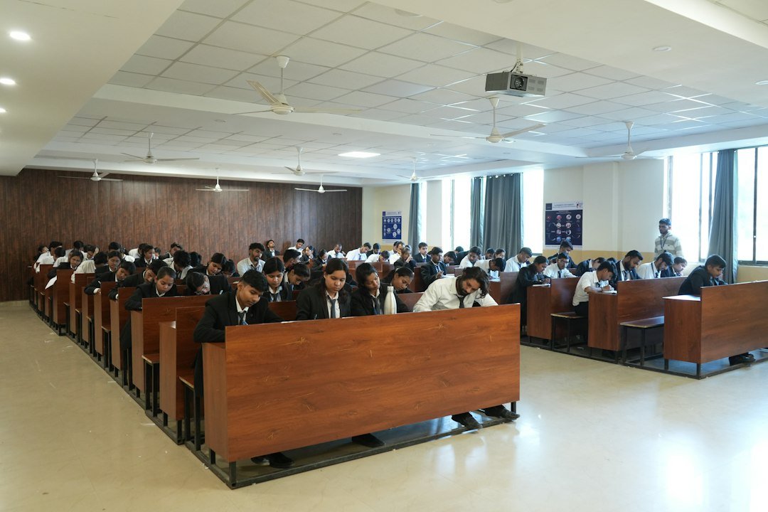 Candidates taking a computer-based examination, illustrating DSSSB admit-card guidance