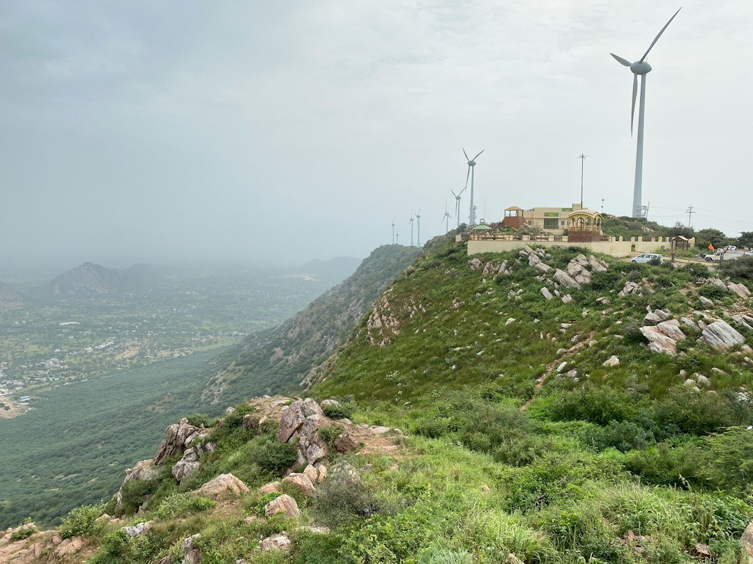 Wind turbine on a hill representing renewable energy and grid storage