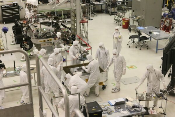 Engineers assembling a planetary exploration rover in a laboratory