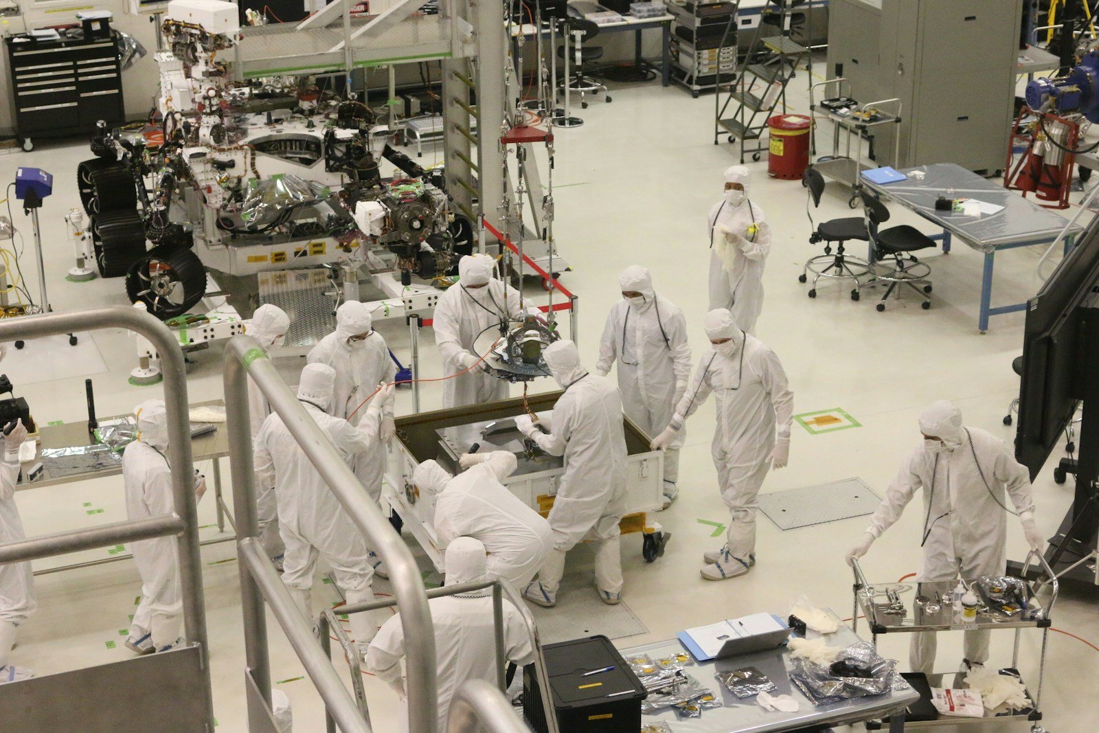 Engineers assembling a planetary exploration rover in a laboratory