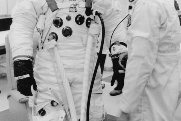Astronaut in a pressurised suit with assistance, illustrating spaceflight medicine and crew safety.