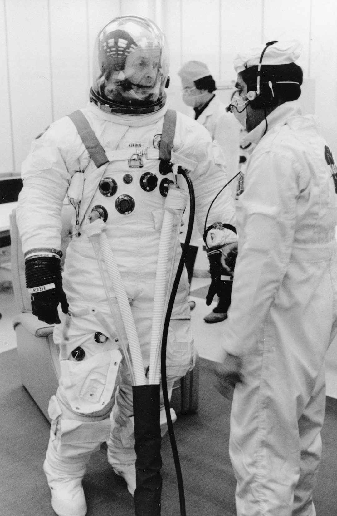 Astronaut in a pressurised suit with assistance, illustrating spaceflight medicine and crew safety.