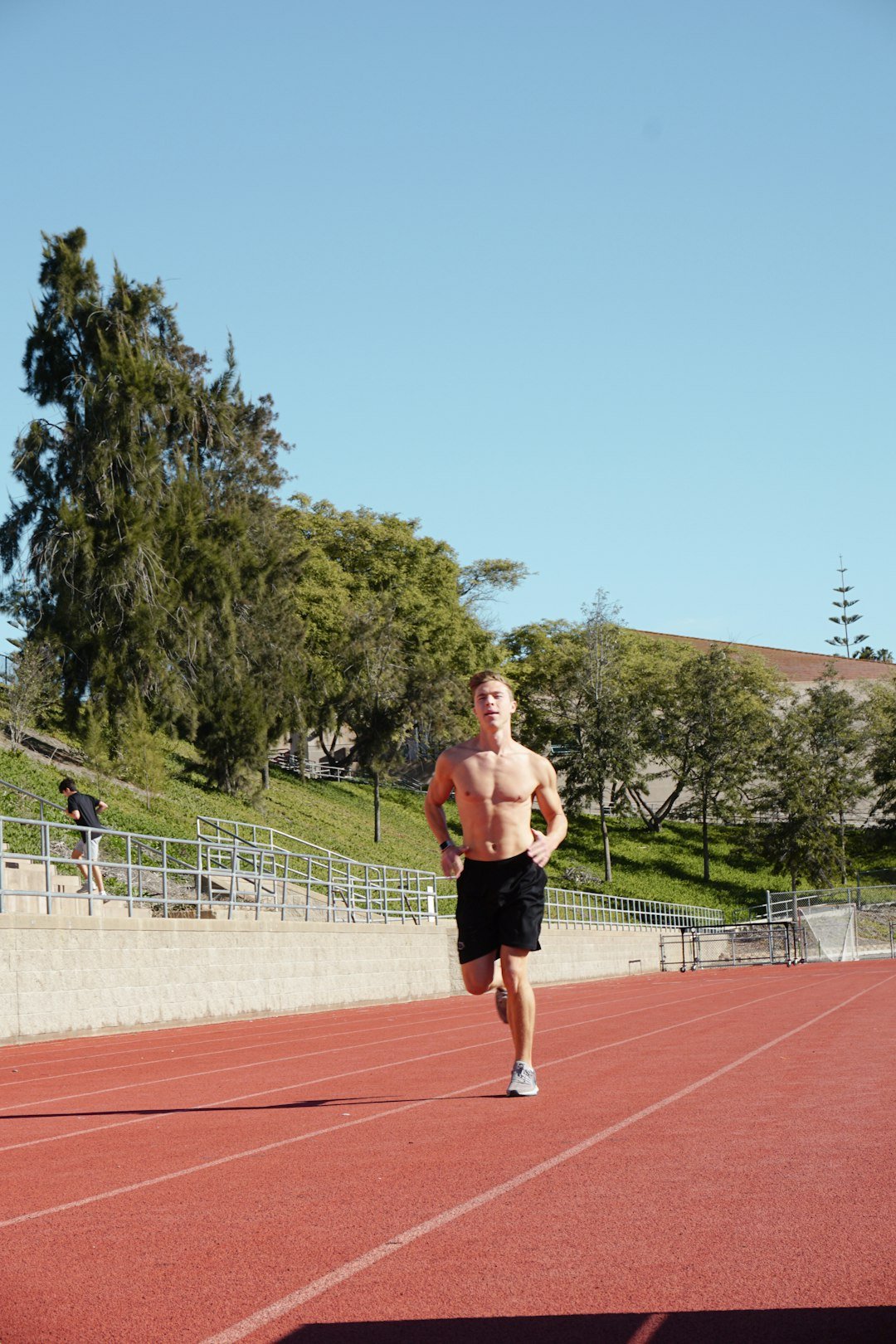 Athlete running on a track illustrating physical endurance tests