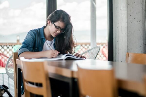 Student studying at a desk, illustrative image for the NMMSS scholarship application guide
