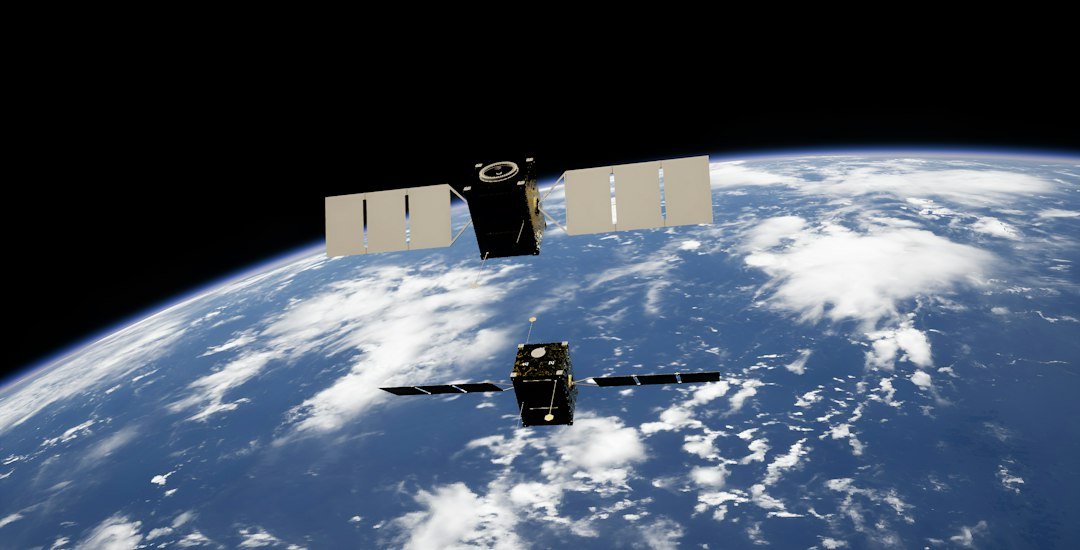 Two satellites with solar panels above Earth, illustrating India's satellite and space technology programme